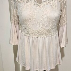 Beautiful lace top with delicate sleeves.
